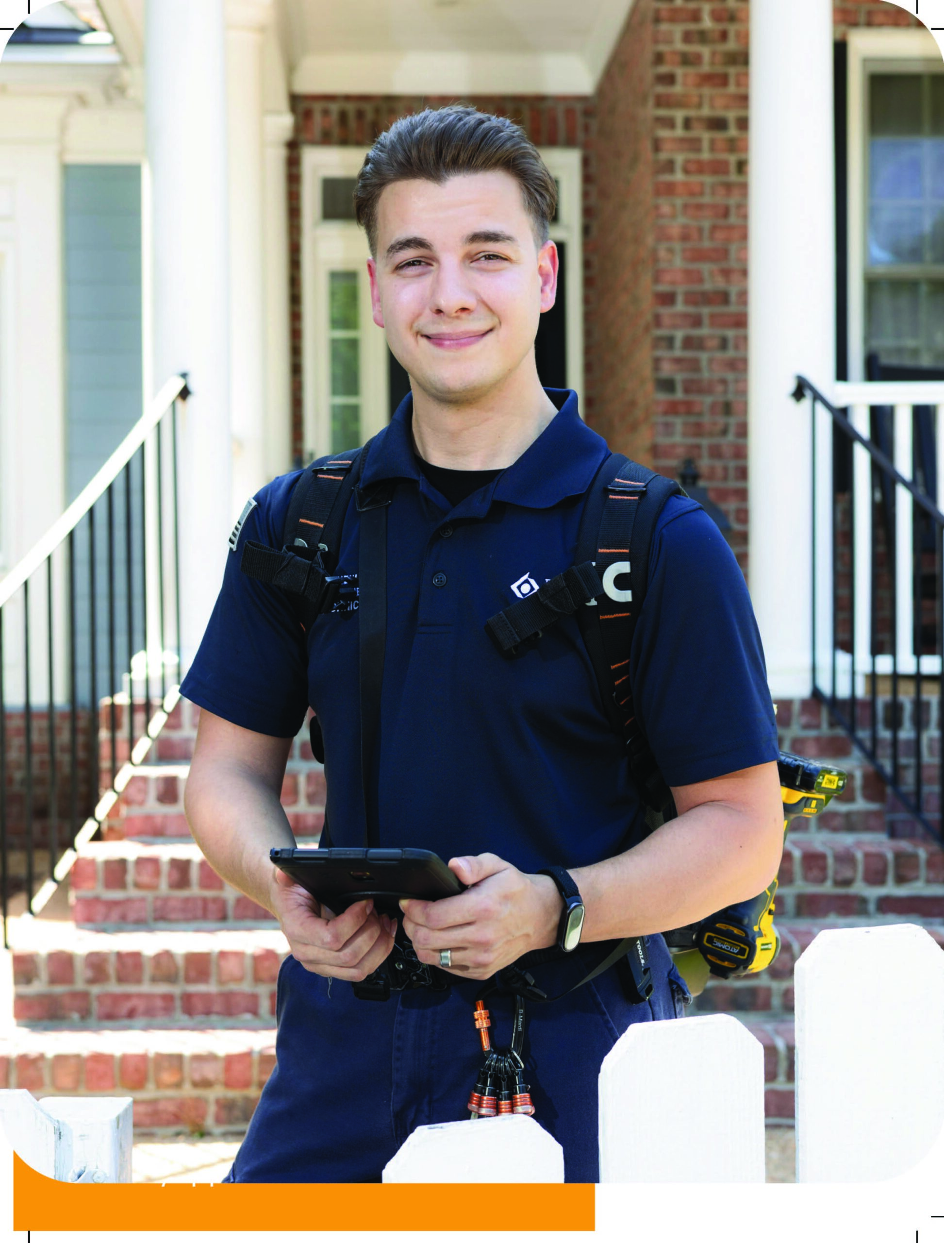 Matthew Briggs, owner and lead technician at Best Day Appliance, holding his tablet outside a home